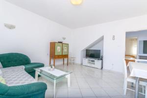 a living room with a couch and a table at Apartments Terrace in Postira