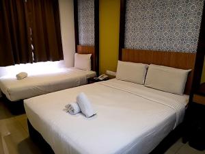 Postel nebo postele na pokoji v ubytování South of The Clouds HOTEL KL Sentral 吉隆坡彩云之南酒店-中央车站店