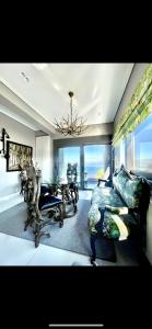 a living room with a couch and a chandelier at Luxury Apartment Sea View Chalkida in Chalkida