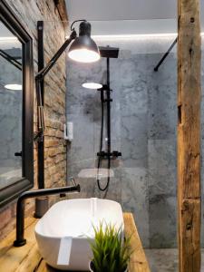 a bathroom with a white tub and a shower at Casa Larisa Antonia Apartments in Sinaia +43 photos