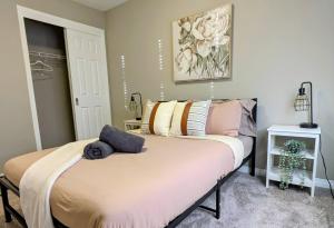 a bedroom with a bed with pillows on it at A Slice Of Heaven In Airdrie By Eagleswingshomes1 in Airdrie