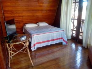 Ένα ή περισσότερα κρεβάτια σε δωμάτιο στο Enseadinha Guarapari