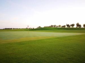 a view of a golf course with a putting green at Marrakech Premium Dar Aicha in El Gouassem