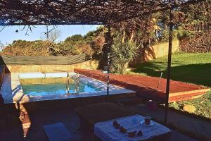 a swimming pool in a backyard with a wooden deck at Finca con Piscina en Doniños in Ferrol