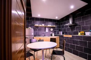 a kitchen with a table and chairs in a kitchen at Finca con Piscina en Doniños in Ferrol