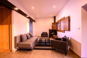 a living room with a couch and a chair at Finca con Piscina en Doniños in Ferrol