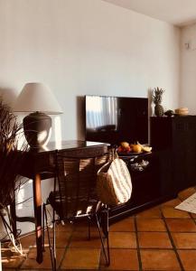 a room with a desk with a lamp and a television at Oceanfront Studio in Fort Lauderdale in Pompano Beach