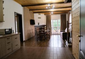 a kitchen and living room with a couch and a table at Мигово Гражда in Migovo