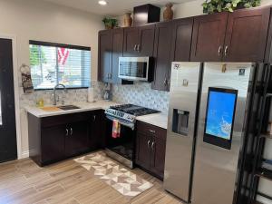 a kitchen with a refrigerator and a stove top oven at Elegant private studio with private entrance and pool access in San Gabriel