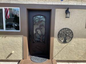 a black door with a window on a house at Elegant private studio with private entrance and pool access in San Gabriel