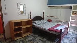 a bedroom with a bed and a book shelf at Grand Bay Dominica Sunrise Guesthouse in Tête Morne +9 photos