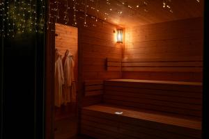 a sauna with a bench in a room with lights at Cabin Westerwald Sauna, 5G Internet, E-Ladesäule in Niederdreisbach +38 photos