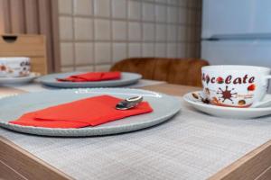 a table with two plates and a cup of coffee at Christina's Cozy Apartment Volos in Volos