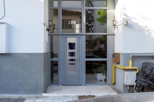 a front door of a building with a door with at Christina's Cozy Apartment Volos in Volos