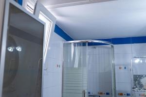 a bathroom with a shower and a staircase at Christina's Cozy Apartment Volos in Volos +27 photos