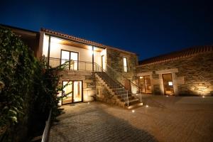 a building with a staircase in front of it at night at Casa de Trás-o-Muro in Vila Real