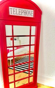 a red telephone booth sitting in a room at Taswell House in Portsmouth