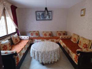 a living room with a couch and a table at The Orchard Cozy & Comfy Apartment 1 in Ifrane