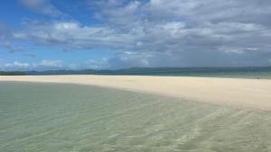 a sandy beach with the ocean in the background at Maria Kulafu Lodging House Pier site- Santa Clara office 2nd Floor in Cagba