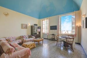 a living room with a couch and a table at Ca Moretto - Happy Rentals in Sanremo
