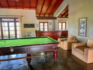 a living room with a pool table in it at Tibline by Gotravelfix in Kudadeniya