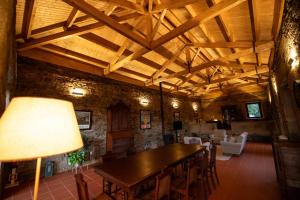 a dining room with a wooden table and chairs at Casa de Trás-o-Muro in Vila Real