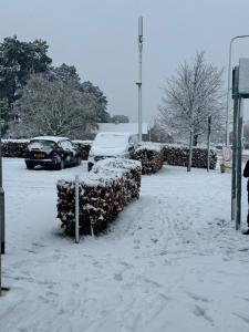 a parking lot covered in snow with parked cars at The Metro Oasis in Edinburgh