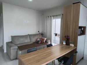 a living room with a couch and a table at Apartamento Praia centro 03 in Penha