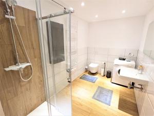 a bathroom with a shower and a sink and a toilet at Apartmenthaus Bargteheide Apartment 1 in Bargteheide