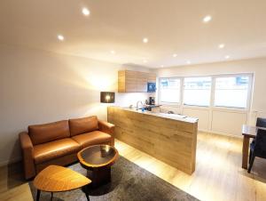 a living room with a couch and a table at Apartmenthaus Bargteheide Apartment 1 in Bargteheide