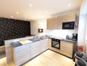 a kitchen with a sink and a microwave at Apartmenthaus Bargteheide Apartment 1 in Bargteheide +16 photos