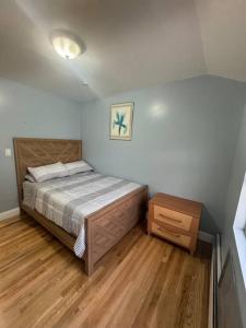 a bedroom with a bed and a wooden floor at Luxury apartment close to JFK Airport in Hamilton Beach