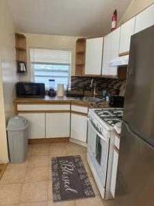a kitchen with a stove and a kitchen rug on the floor at Luxury apartment close to JFK Airport in Hamilton Beach