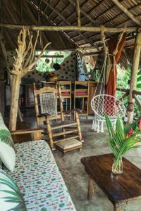 a living room with a couch and a table and chairs at Bungalows India, El Valle, Samana in Santa Bárbara de Samaná