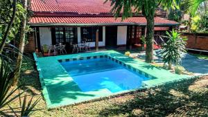 a swimming pool in front of a house at Posada de Ana in Puerto Iguazú