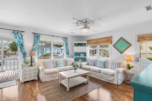 a living room with two couches and a table at The Marlin House 143 Marlin Drive home in Holden Beach