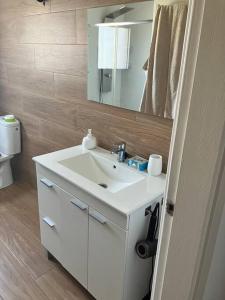a bathroom with a white sink and a mirror at Descanso del GUERRERO in San Miguel de Fluviá