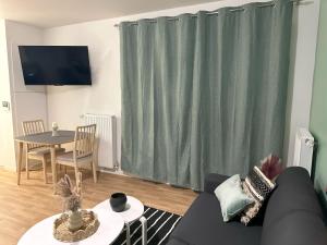 TV a/nebo společenská místnost v ubytování Appartement Cosy au Stade de France Proche Paris