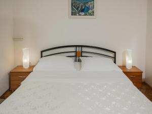 a bedroom with a white bed with two night stands at Villa in Croatia near Blue & Red Lakes in Imotski +28 photos