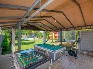 a patio with a grill and a pool table at Villa in Croatia near Blue & Red Lakes in Imotski