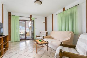 a living room with a couch and a table at Apartments by the sea Postira, Brac - 739 in Postira