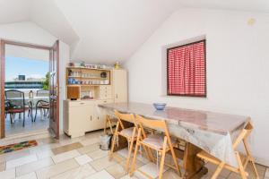 a dining room with a table and chairs at Apartments by the sea Postira, Brac - 739 in Postira