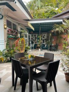 a black table and chairs on a patio at St. John Island View Pensionne in El Nido