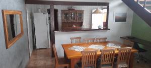 a dining room with a wooden table and chairs at Casa Ilhabela in Ilhabela +9 photos