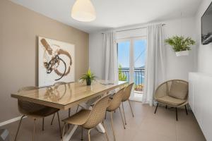 a dining room with a table and chairs and a balcony at Apartments with parking space Rabac, Labin - 3015 in Rabac +22 photos