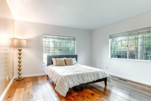 a white bedroom with a bed and two windows at 12 Mi to Folsom Historic District NorCal Getaway in Fair Oaks