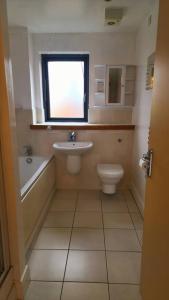 a bathroom with a sink and a toilet and a window at City Bliss Great Location in Birmingham