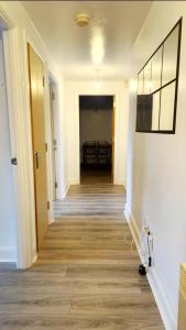 an empty hallway with a hallway leading to a dining room at City Bliss Great Location in Birmingham +2 photos