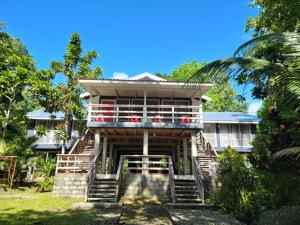 a house with stairs leading up to it at Seghe Accommodation in Seghe