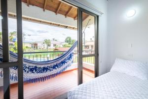 a bedroom with a hammock and a balcony at Hotel Chalet La Sofia by Majuva in Armenia +123 photos